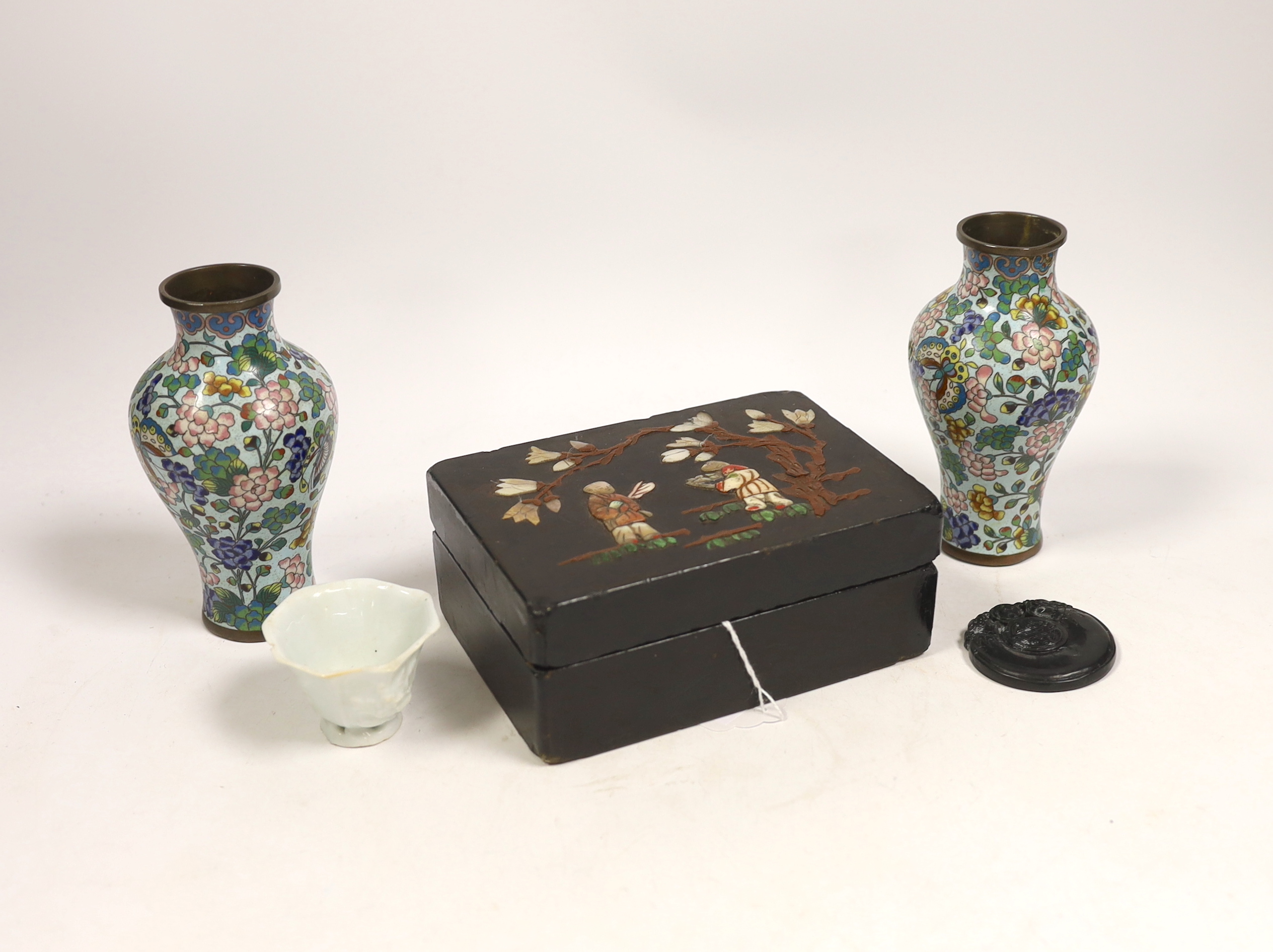 A pair of Chinese cloisonné enamel vases, 12.5cm, a lacquered box with mother of pearl inlay, a carved black stone disc, 5cm diameter, and a miniature ceramic pot (5)